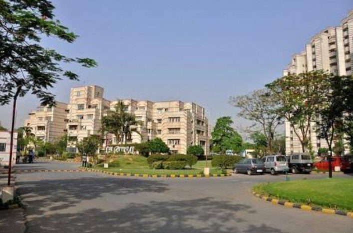 A residential apartment complex with a landscaped entrance in South City 1, Gurgaon